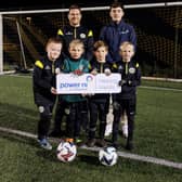 Pictured (L-R) is Power NI employee and Knockbreda Football Club coach Saul Lockhart with Power NI’s Myles Grant. They are joined by players from Knockbreda Football Club’s Under-9 squad.