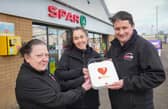 Jacqueline Funton, Joanne Tweed and Peter Kaye from SPAR Craigyhill who have fundraised with their shoppers to install an Automated External Defibrillator outside their store in Larne.