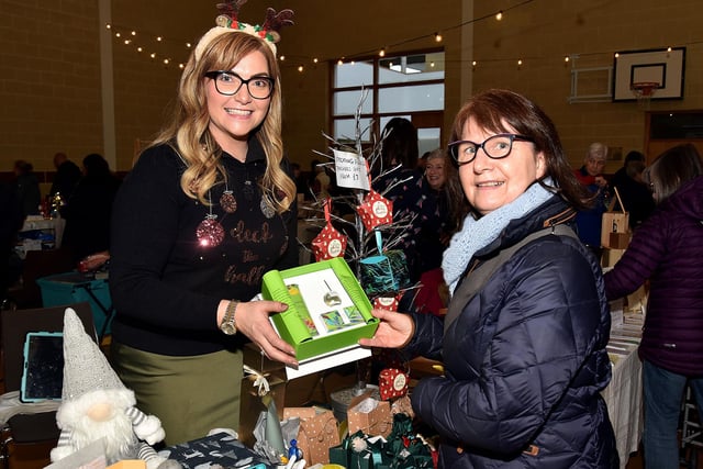 Leanne Brown of Tropic Skincare discusses products with Dawn Nesbitt at the Shankill Parish Christmas Market on Saturday. LM50-210.