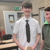 Northern Regional College Joinery apprentice Cathal McLaughlin shows student Rys Clarke his work.