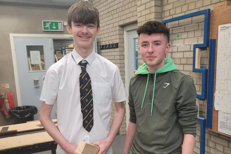Northern Regional College Joinery apprentice Cathal McLaughlin shows student Rys Clarke his work.