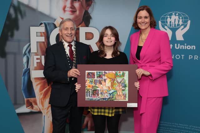 Martin Busch, president of the Irish League of Credit Unions, Naoishe Johnston of Antrim Credit Union, winner of the 14–17-year-old (AN) category and MC Grainne McElwain. Photo by: Robbie Reynolds Photography