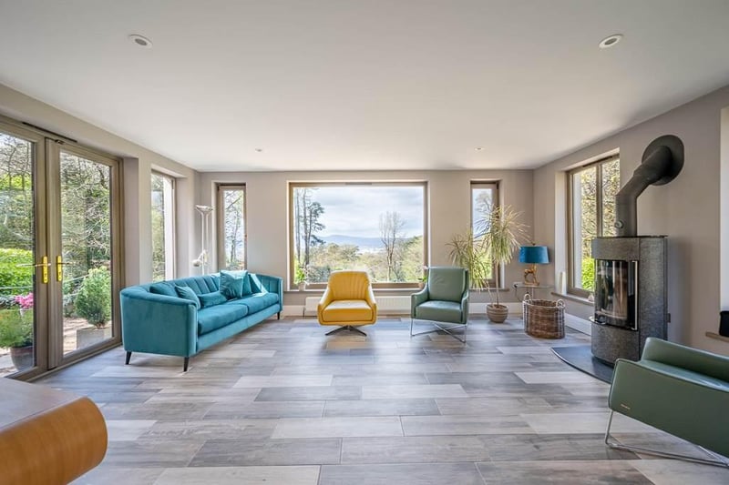 The sun room features stunning views to the mature gardens, Belfast and the Antrim hills beyond.