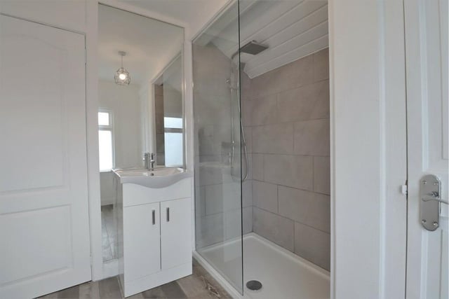Separate modern shower room with walk-in shower.
