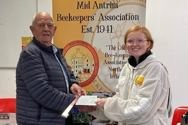 Sarah pictured receiving her sponsorship cheque from Robin Currie, treasurer of Mid Antrim Beekeepers’ Association.