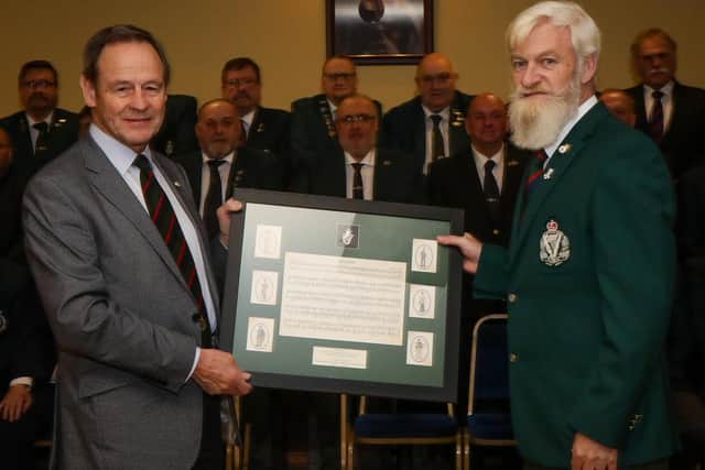 Association President Mr Paddy McQuaid presented The Deputy Lord Lieutenant Freddie Hall with a framed picture depicting the history of the Royal Irish Regiment. Pic credit: Norman Briggs, rmbphotographyni