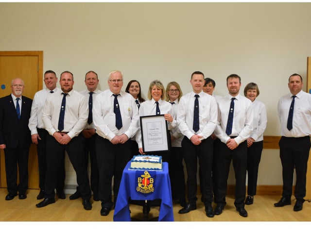 Officers and leaders of the company pictured during the 80th anniversary church service.