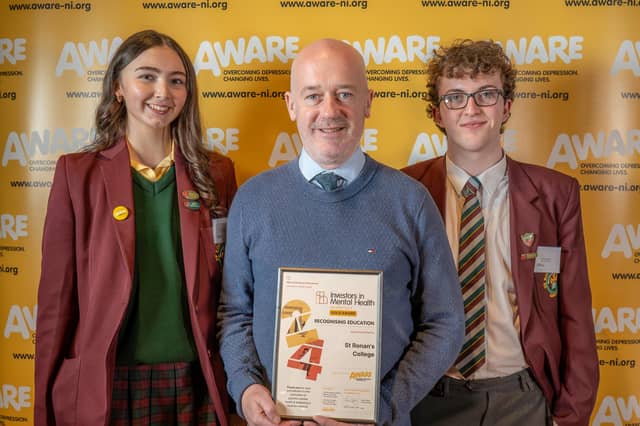 A member of staff and students from St Ronan's College in Lurgan collect their award after the school was recognised for their dedication to promoting positive mental health. The school has integrated AWARE NI’s mental health programmes such as Mood Matters Young People into their curriculum and also maintained a consistent focus on mental health through initiatives like signposting, appointing mental health champions and creating dedicated mental health spaces, including a gardening project.