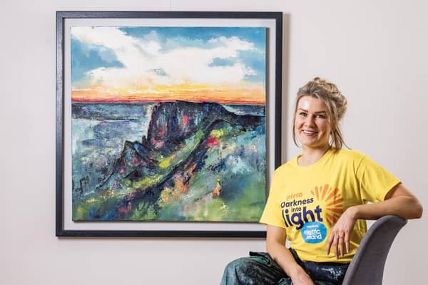 Artist Anna McKeever with her painting Cavehill at Sunrise.