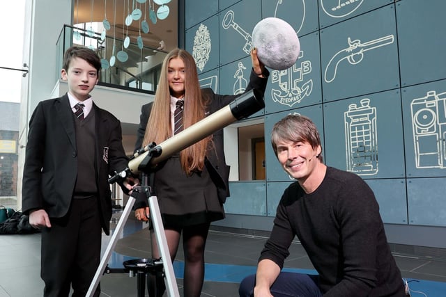 Professor Brian Cox attending Summer Science School event in collaboration with Mid & East Antrim Borough Council with Cullybackey College students Kyle Corbett (left) and Aimee Taylor (right).