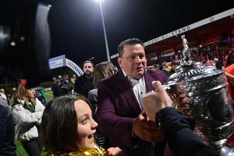 Larne owner Kenny Bruce lifts the Gibson Cup for the first time in Larne’s 134-year history.