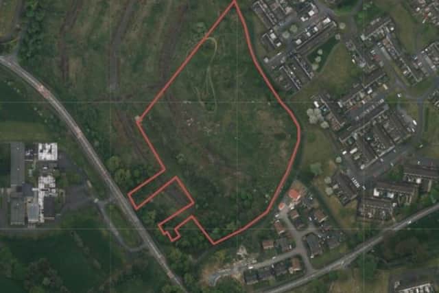 An aerial view, shown to members of the planning committee, with the proposed site of development highlighted in red.