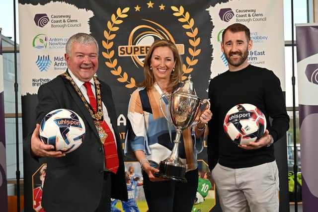 Mayor of Causeway Coast and Glens, Councillor Ivor Wallace, event M.C. Claire McCollum and Northern Ireland international Niall McGinn at the SuperCupNI draw