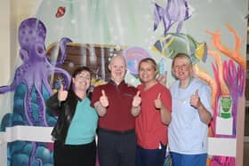Artist Carla Hodgson, service user Ben McAllister, Ward Manager Charlotte McKeeman and Autism Awareness Champion Donna Smith celebrate the completion of the murals at Causeway Hospital’s Day Procedure Unit.