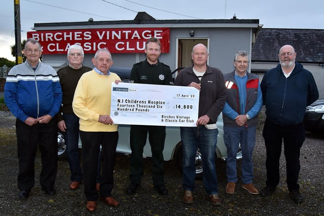 Portadown PSNI Inspector Adam Ruston, centre, pictured with members of the Birches Vintage and Classic Vehicle Club who raised £15,000 for the Northern Ireland Children's Hospice at a Big Country Night in the Seagoe Hotel recently. The club would like to thank Inspector Ruston for all his help at the event. PT16-201.