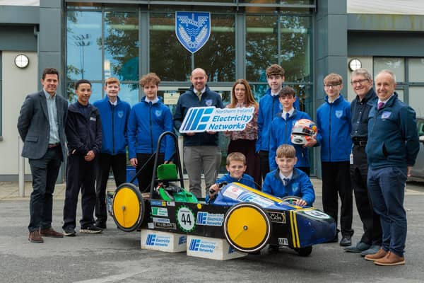 Pictured together are Ballyclare Secondary’s ‘Forget Fossil Racing’ team  who are competing at the international Greenpower competition finals  at Goodwood Motor Circuit with support from NIE Networks.  Pictured L-R Kyle McMullan, NIE Networks; Dylan Darkoh, NIE Networks Apprentice & Ballyclare Secondary Past Pupil; Jason (Year 12); Jayden (Year 12); Mr A. Graham, Ballyclare Secondary; Mrs W. Shingleton, Acting Principal Ballyclare Secondary; Riley (Year 12); Ryley (Year 12); Joss (Year 12); Trevor Girvan, NIE Networks; Mr. D. Beckington, Ballyclare Secondary. FR – Joey (Year 9); Charlie (Year 9).  Photo: Conor Palin-Stewart