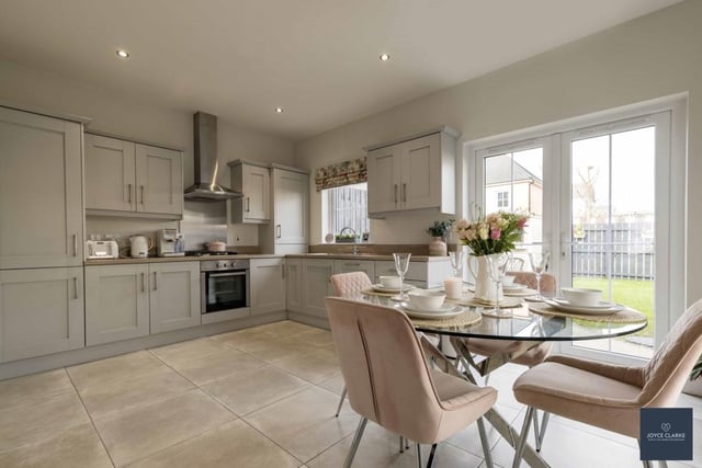 The spacious kitchen diner has a range of appliances include four-ring gas hob with stainless steel splashback and extractor canopy above, electric oven, integrated fridge freezer and dishwasher.