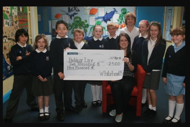 Jenny Heaney of Joymount Presbyterian Church receives £2500 for the Fields of Life Charity, the money was raised through a celebrity day and talent show at Whitehead PS in 2010.