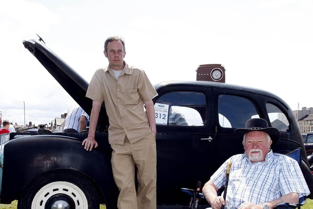 Gerald Dallat and his son Gerard relax with their 1952 Prefect during the Ford Fair at the Dunluce Centre in 2009