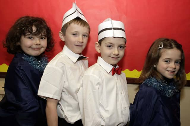 SINGING WAITERS. P3/4 pupils at St Brigid's PS who took the role of 'Waiters and Gospel Singers' during their Christmas Play in 2008