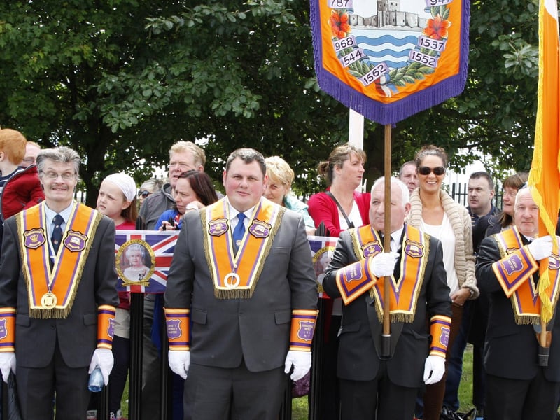 Carrick District office bearers welcome visiting East Antrim lodges to the field at Woodburn. INCT 29-076-tc