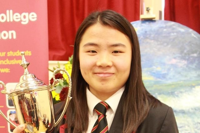Year 14 student, Christine, receives the Lynne Loughrin Memorial Cup for Humanitarian Work at ICD’s Senior Prize-Giving Ceremony.