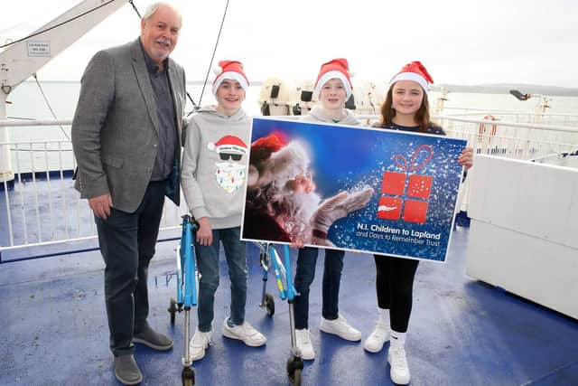Gerry Kelly, President, Northern Ireland Children to Lapland and Days to Remember Trust with Oliver Dickey, Max Dickey and Holly Lamont from Coleraine