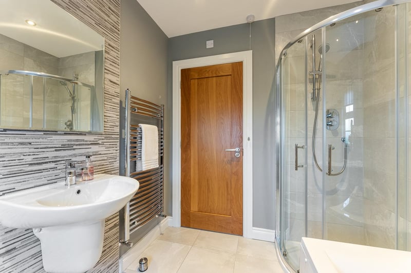 The beautiful family bathroom is comprised of a four piece white suite featuring a panel bath with handheld shower attachment, floating sinkual flush WC and corner shower enclosure with mains fed shower. There is also a heated towel rail.