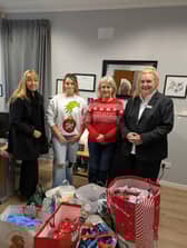 Barbara Wilson, Funeral Manager, and Sandra Williamson, Senior Funeral Arranger, from John Gray and Co handing donations to Women’s Aid