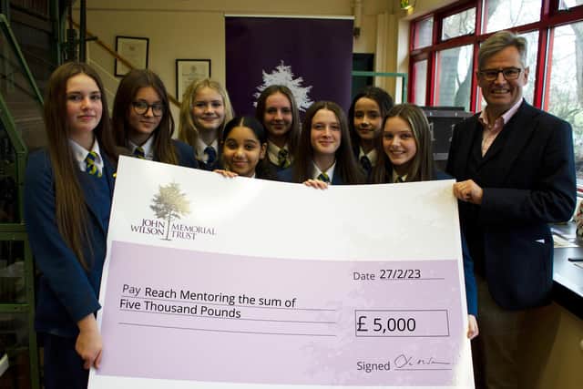 Dr John Wilson, Chairman of Ulster Carpets and Trustee of the John Wilson Memorial Trust, presents the team from Clounagh JHS with a cheque for £5,000 for their chosen charity, Reach Mentoring.