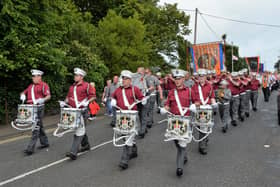 Carrickfergus Defenders Flute Band taking part in the Twelfth parade in Larne in 2019.