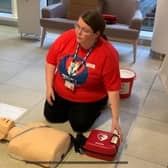 Resuscitation Services Assistant, Sarah McKee demonstrating how to use a defibrillator machine