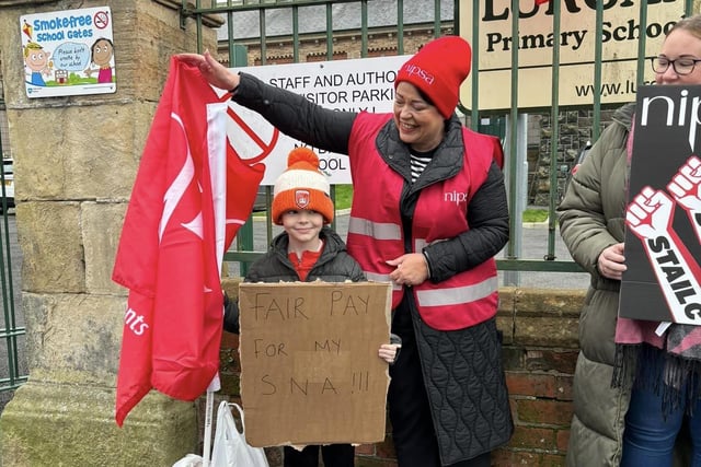 A special photo for Barra with his own Special Needs Assistant outside Lurgan Model Primary School, Brownlow Terrace, Lurgan, Co Armagh.  Hundreds of school support staff from unions such as Unison, Unite, GMB and NIPSA joined the strike on the second day in what will be one of the biggest strikes among non-teaching unions in years. The ongoing industrial dispute is over the failure to deliver a pay and grading review to education workers as part of a negotiated resolution of the 2022 pay dispute.