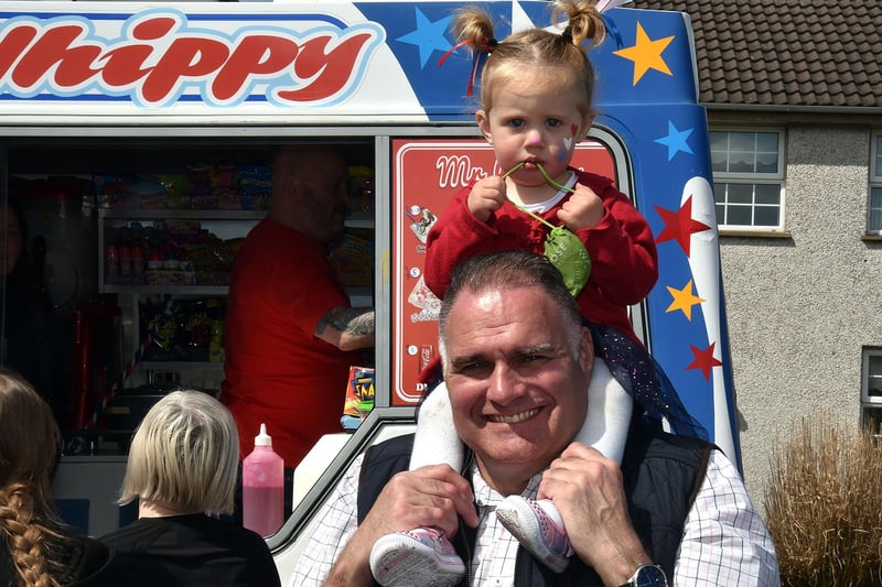 Olivia-Lyn Herbert (18 months) gets a great view of the coronation party on the shoulders of grandad, Jeff Herbert. PT18-219.