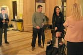 Michelle O'Neill says she did not know the whereabouts of her former colleague Michael McMonagle (left, highlighted) during the period this image was taken. This still from a video taken by BBC Northern Ireland in February 2023 shows Michelle O'Neill standing a few yards from him. He was suspended from the party at the time after it emerged he was being investigated by police for child sex offences - he has subsequently been convicted. The First Minister said “I was not aware that Michael McMonagle was at that event.”