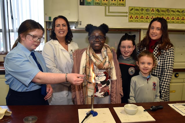 St John the Baptist's College Year 10 student Megan McQuaid demonstrated burning magnesium in the Science department during the school open day watched by Head of Science, Mrs Susan Carolan; Makaneka Sibanda (10), Kamie-Lee McCann (11), Lacey McCann (6) and Gemma Duffy. PT03-211.