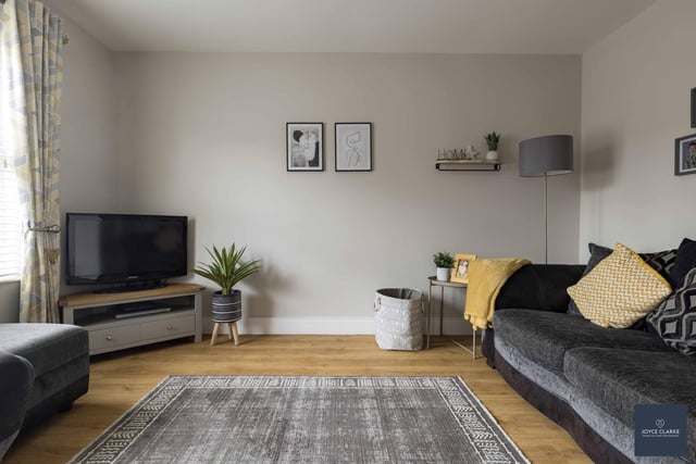 The front aspect snug has a TV point, double panel radiator and wood effect laminate flooring.