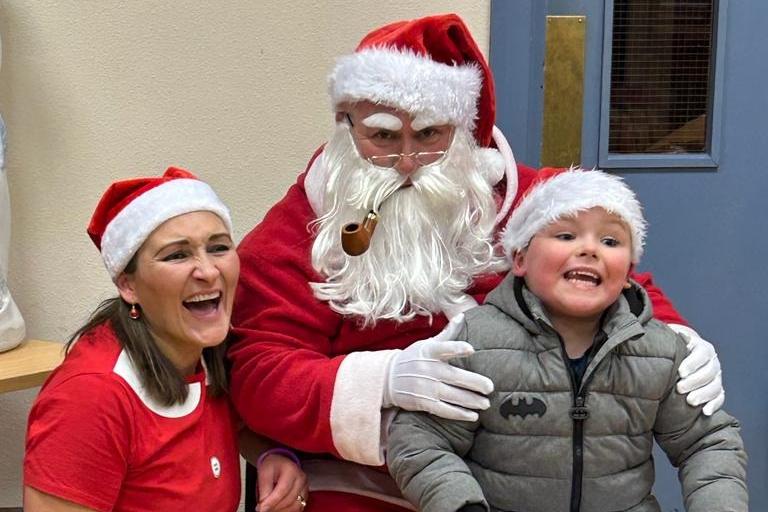 NI Fire and Rescue Crew Commander at Portadown Fire Station Paul Steen took on the role of Santa for their Annual Children's Christmas Party. Fireman Santa is pictured with one of the children who attended.