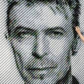 Artist Joe Black adds the finishing touches to a portrait of David Bowie made from over 8,500 guitar plectrums, commissioned by Sky Arts to celebrate Bowie topping a new definitive list of Britain's 50 most influential artists of the past 50 years
