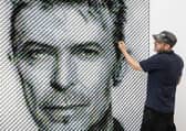 Artist Joe Black adds the finishing touches to a portrait of David Bowie made from over 8,500 guitar plectrums, commissioned by Sky Arts to celebrate Bowie topping a new definitive list of Britain's 50 most influential artists of the past 50 years