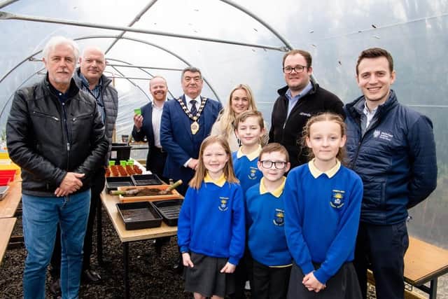 Sunnylands Primary School pupils with guests at the polytunnel during the official opening of the growing space.