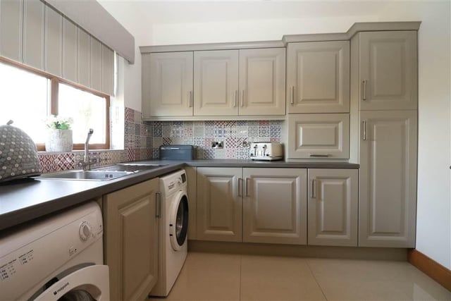 The utility room has a range of high and low level units is plumbed for washing machine and tumble dryer.