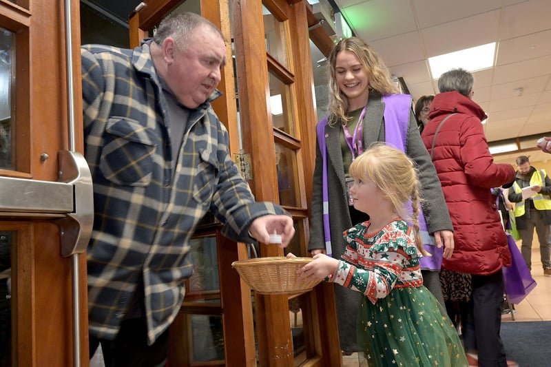 Mia Hamilton handing out candles to guests entering the Lights to Remember service. Mia was doing this in memory of her grandmother.
