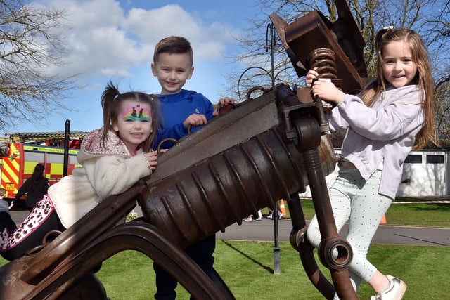 Playing on the steel dog sculpture at Tannaghmore Gardens during Thursday's Fun Day are from left, Albie Foster (4), Joseph Foster (6) and Myla Stockdale (7). PT15-216.