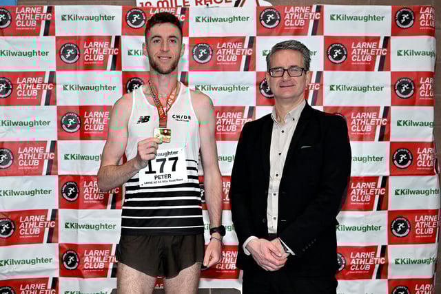 Peter Donnelly from Candour Track Club won the men’s race at the 2025 Kilwaughter Minerals Larne 10 Mile Race is congratulated Gary Wilmot, MD of Kilwaughter Minerals (now part of Saint-Gobain).