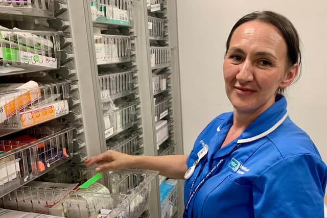 Newly graduated Nurse Laura Carley proudly dons her blue tunic as she takes up her post at the Ulster Hospital. Pic credit: SEHSCT