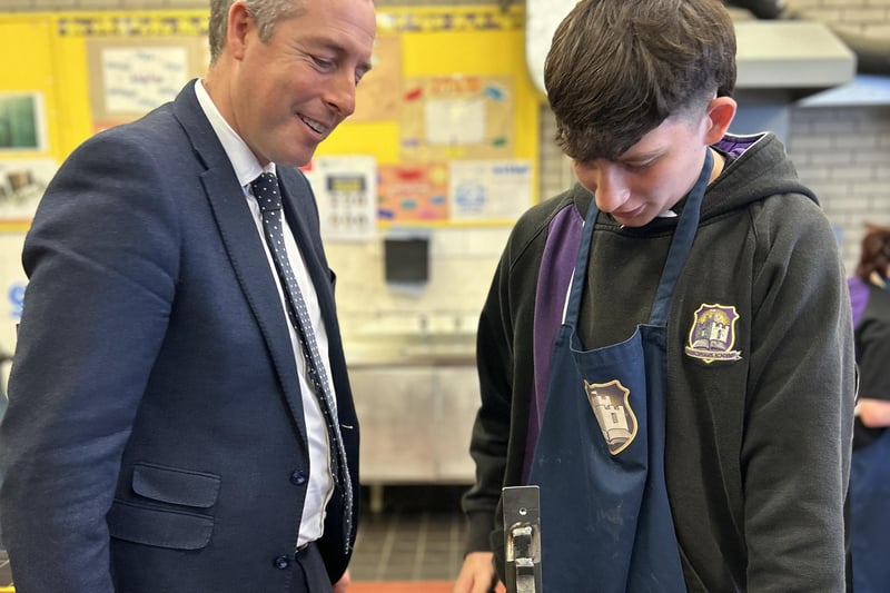 Education Minister Paul Givan watching a demonstration by a Carrickfergus Academy pupil.