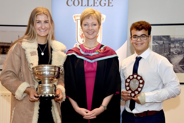 Principal Miss Gillian Gibb presents the Clingan Rosebowl and the Liddell Shield prizes to last year’s head girl and head boy. PT49-225.