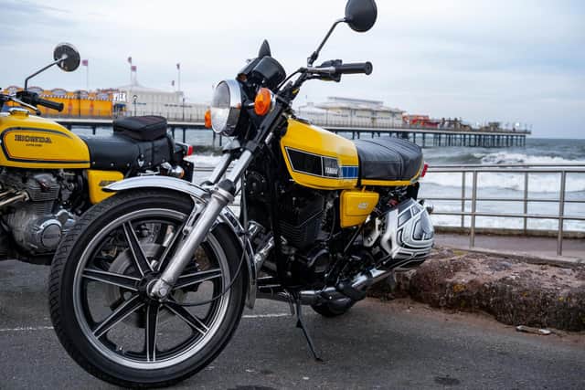 Motorbikes parked down on the sea front.