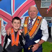Brolly at the ready for any showers during the County Armagh 12th in Lurgan are three generations of the Davison family from left, Richard, Bob (8) and grandad, Tony. TH103.